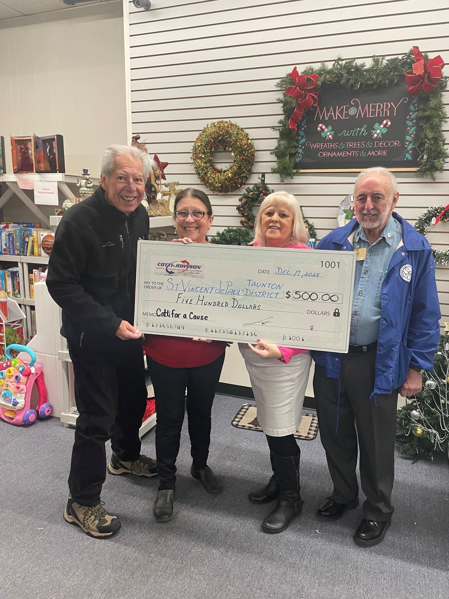 Cotti-Johnson HVAC representatives presenting a $500 check to St. Vincent de Paul Food Pantry, supporting community initiatives during the holiday season.